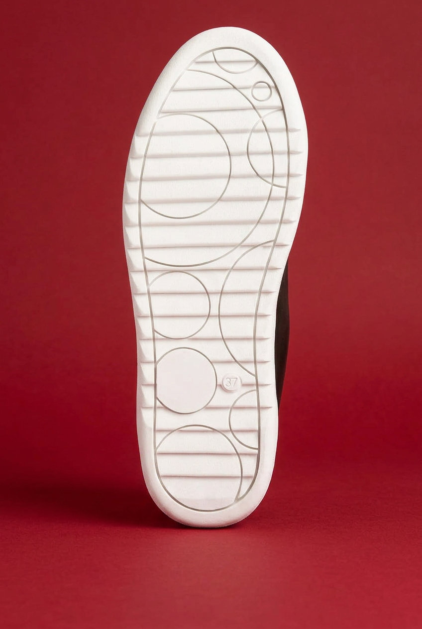Rouxy sneaker outsole on red background