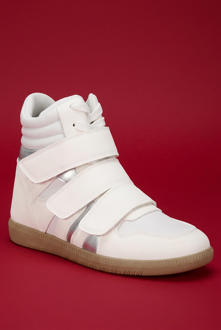 White high-top wedge sneaker front angle on red background