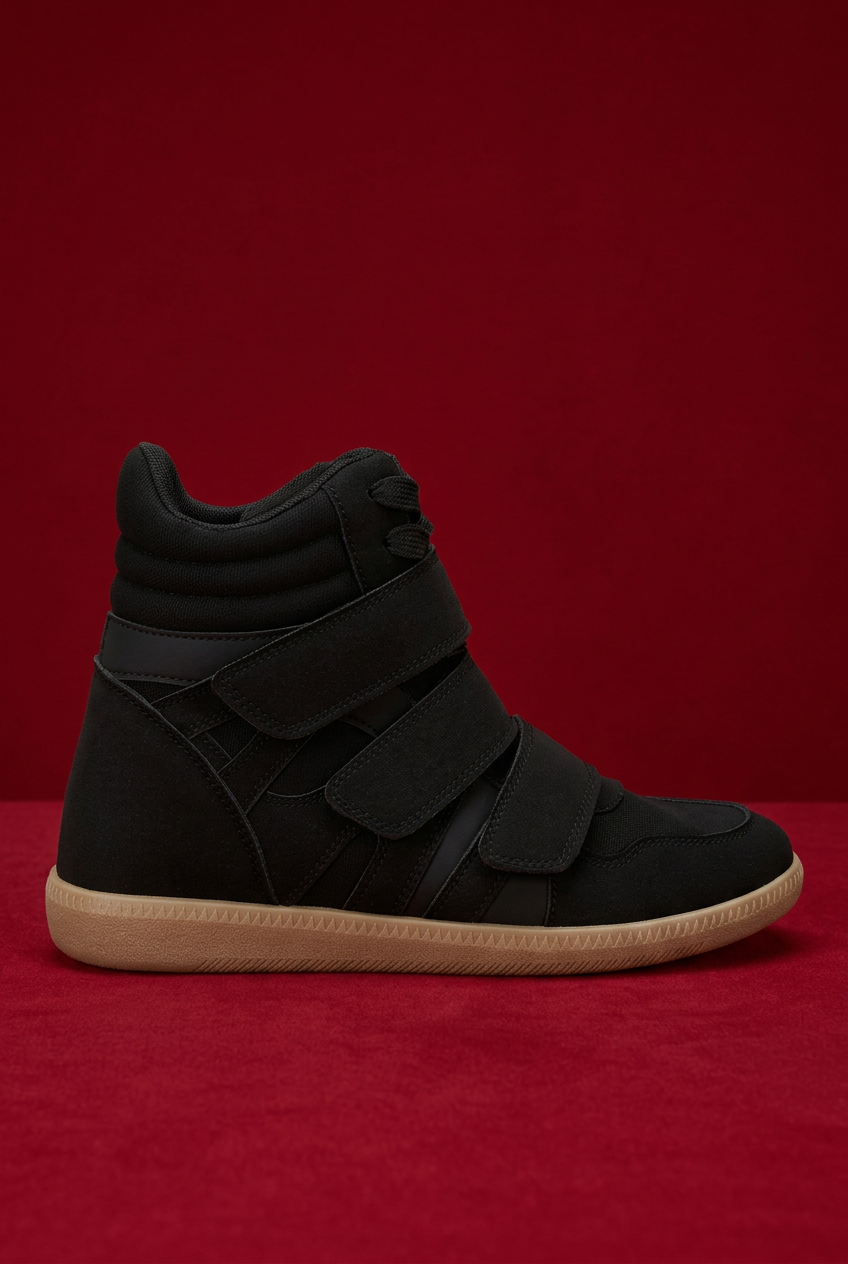 Black high-top wedge sneaker on red background