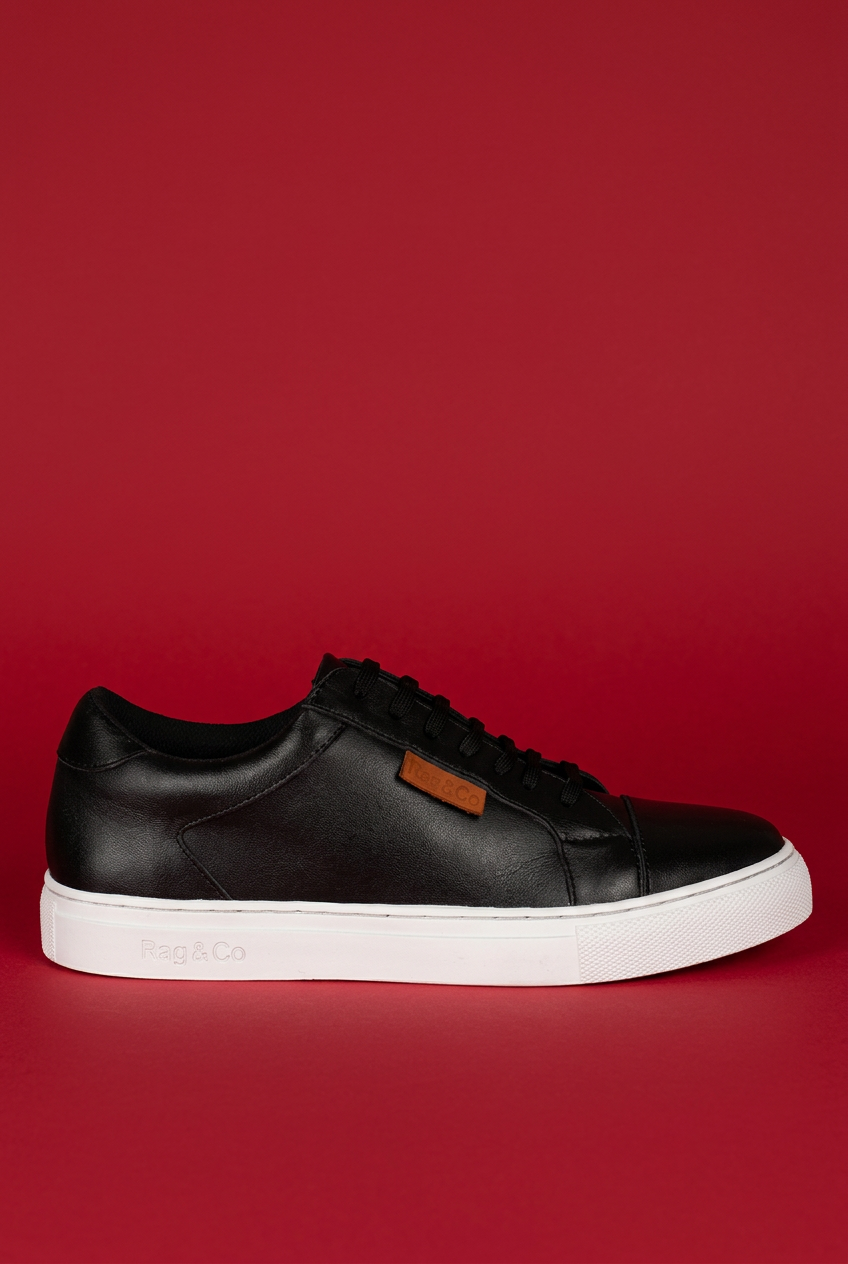 Black Ashford sneaker on red background