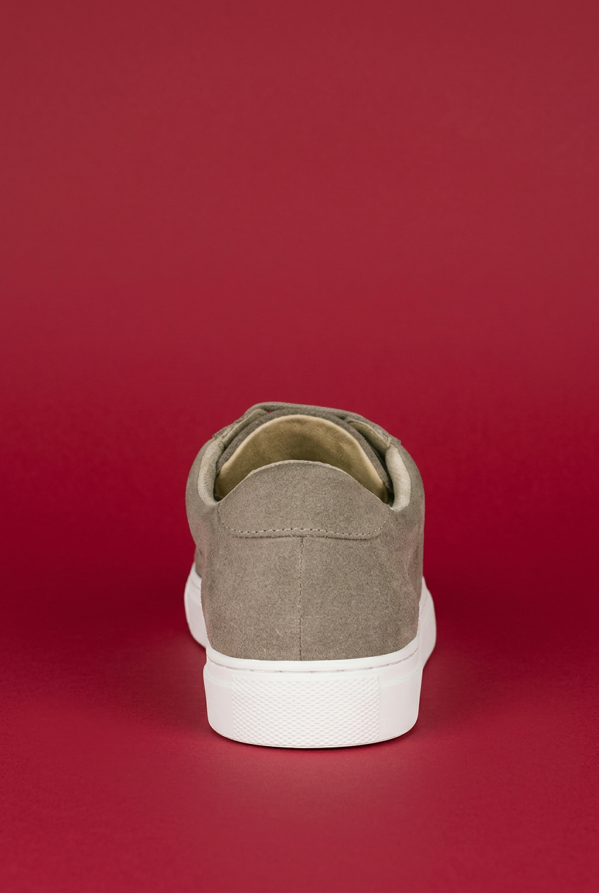 Beige Ashford sneaker rear view on red background
