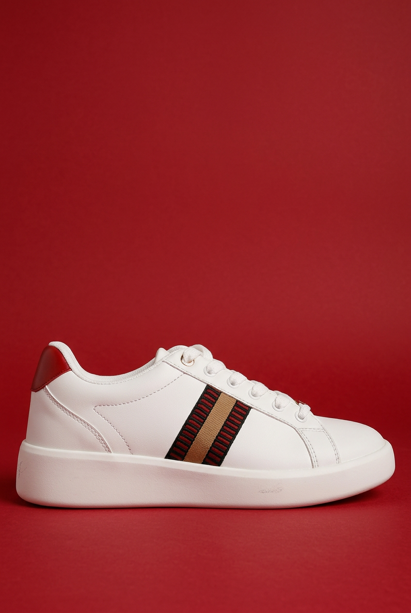White sneaker side view with red background
